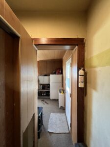 basement-stairwell-exposed-plumbing-linoleum-removal