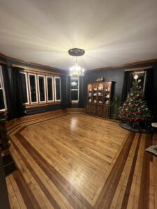 black-dining-room-wall-molding-ornate-maple-floor