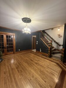 black-dining-room-wall-molding-ornate-maple-floor